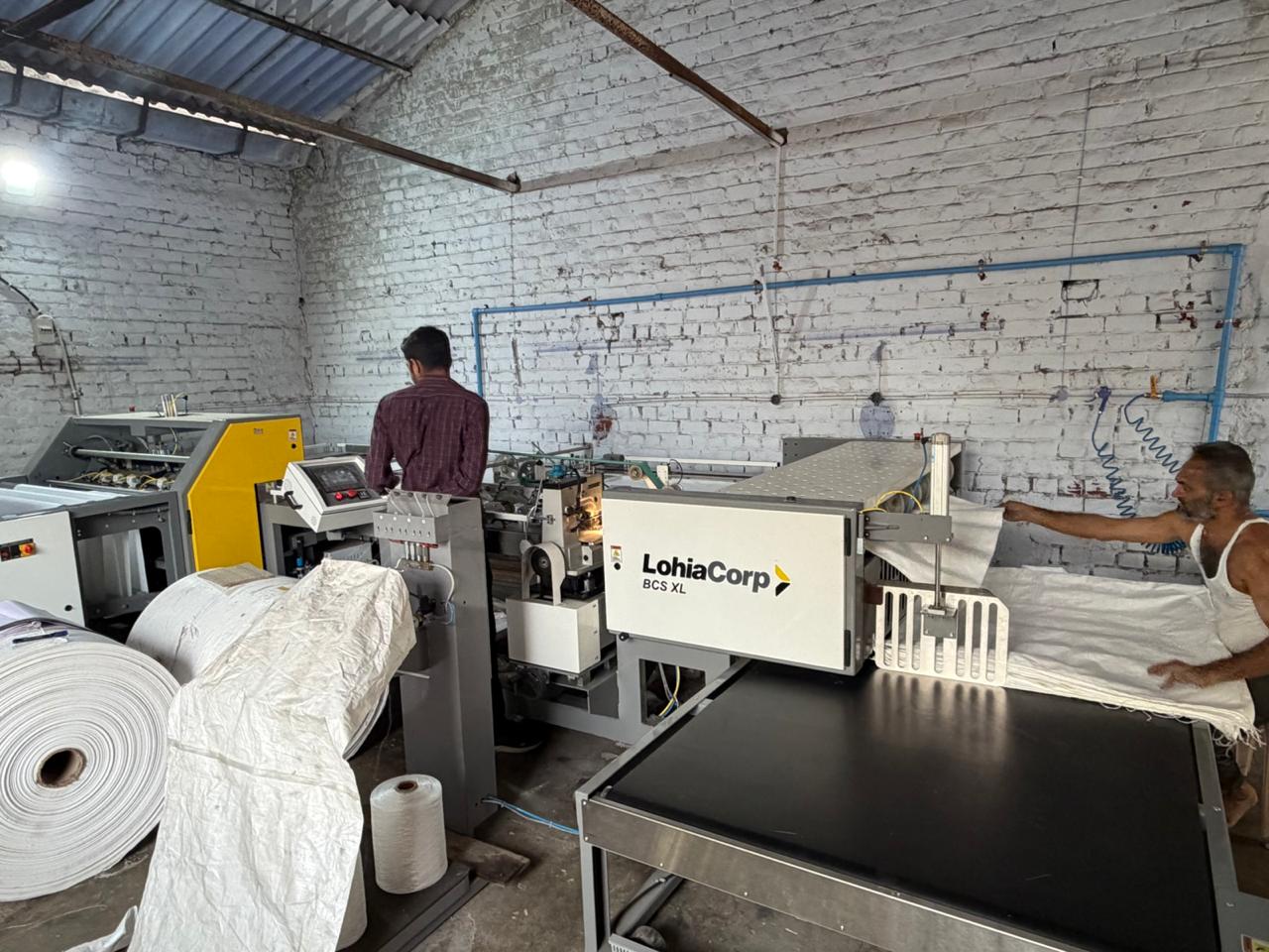 Factory floor — workers and LohiaCorp machine